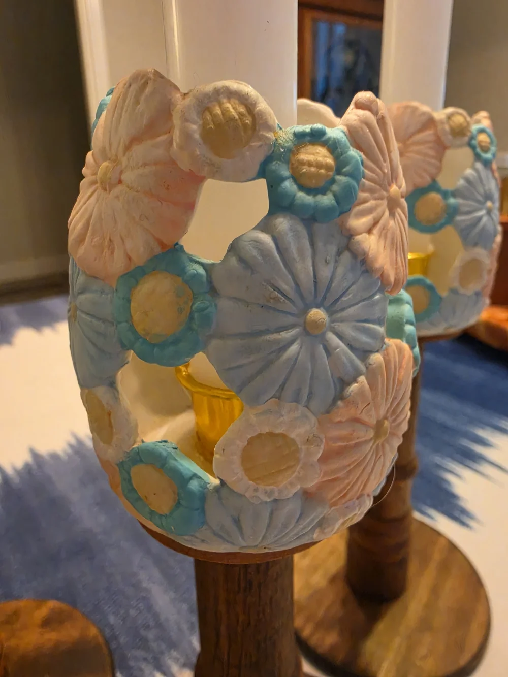 Trio Of Turned dark wood candlestick holders pastel-colored sculpted floral cups